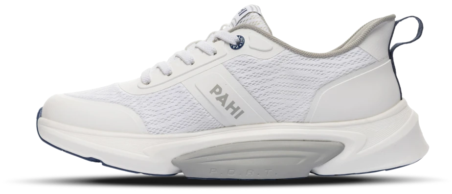 A white PAHI shoe seen from the inside, toe to the left: the sole curves up at the toe and is bevelled at the heel, with P.O.R.T. embossed on the midsole.